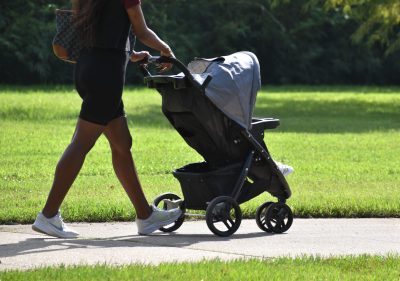 Mother pushing a child in a stroller